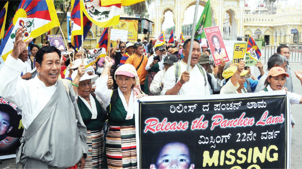 Tibetans take out silent march in city