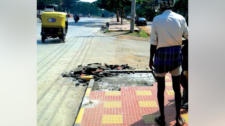 Fix the damaged footpath tiles on Nelson Mandela Road