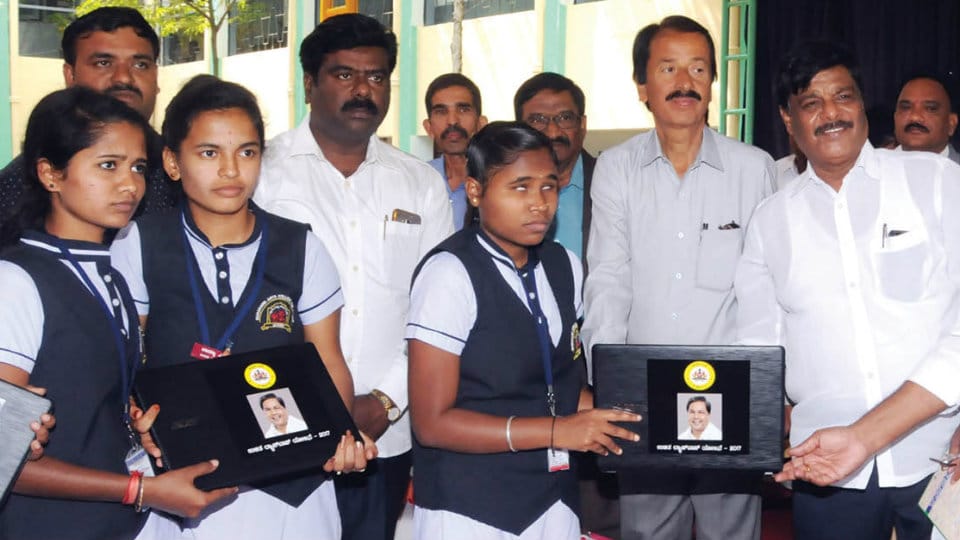 District Minister distributes laptops to 922 SC, ST students