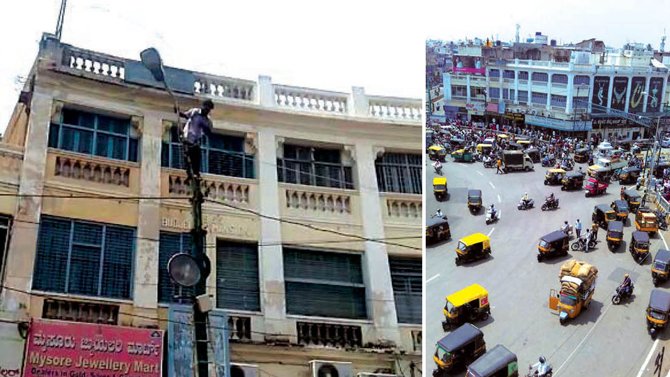 Man climbs atop building at K.R. Circle, threatens suicide