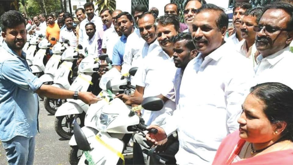 MP distributes three-wheelers to specially-abled