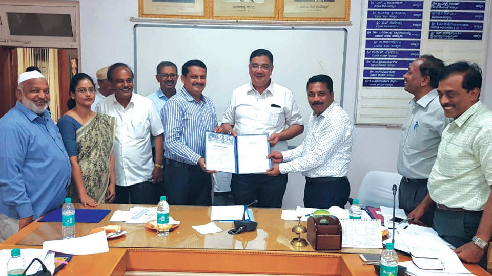 MUDA Comr. hands over CA site allotment letter for construction of library