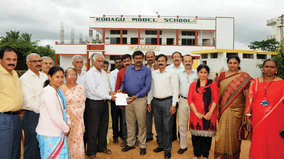 Dharmasthala Rural Development Project hands over Rs. 1 lakh cheque to Kodagu Model School