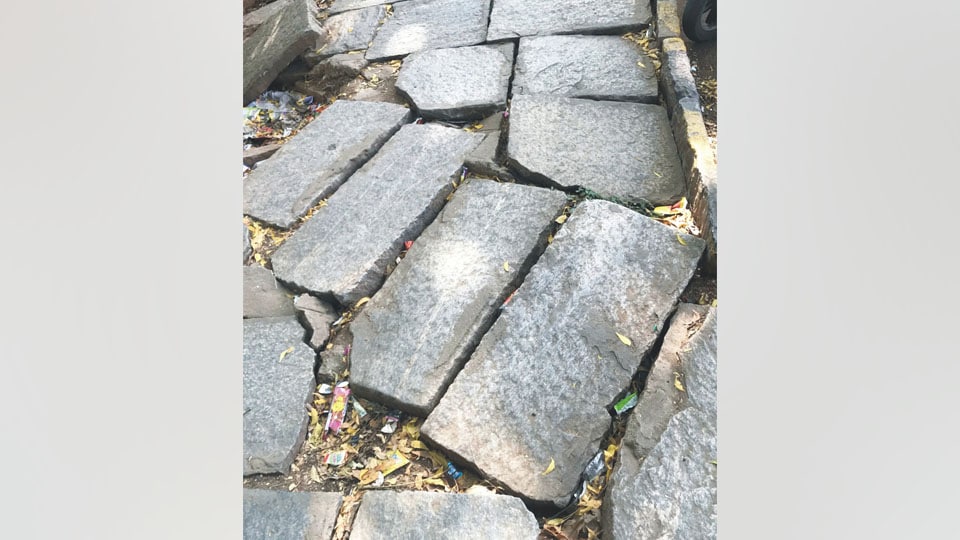 Uneven stone slabs on footpath near Marimallappa School
