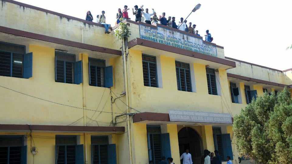 Roof-top protest by Law College students for hall tickets