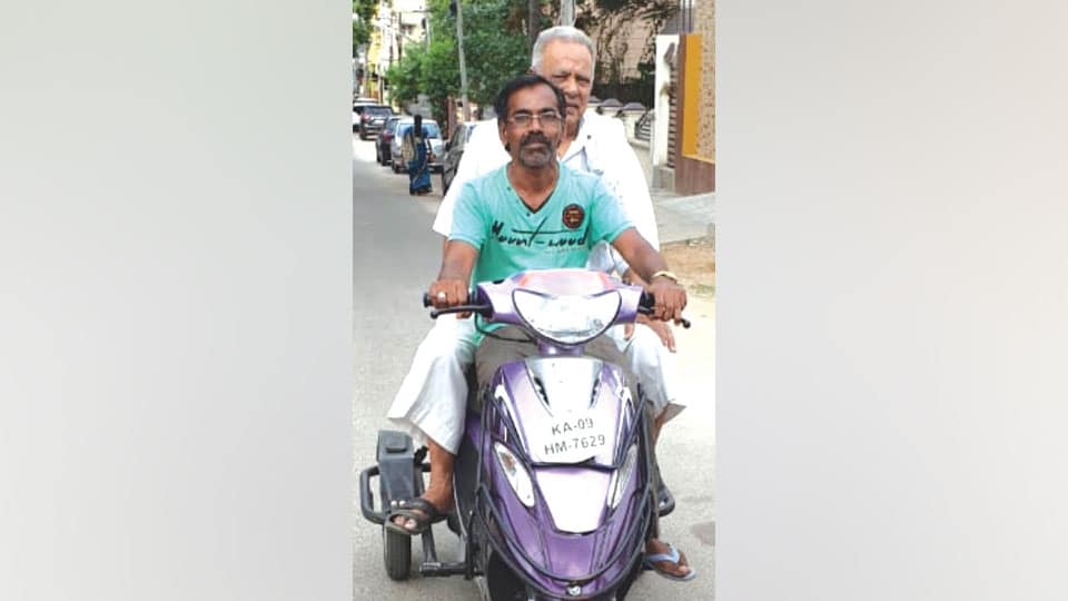 Specially-abled is role model to techies as he carries elderly pillion to polling booth