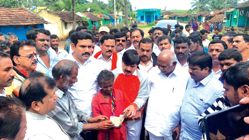 Rs.5 lakh relief cheque presented to flood victim’s family at Hunsur