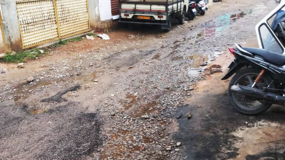 Overflowing manhole and damaged road in Udayagiri