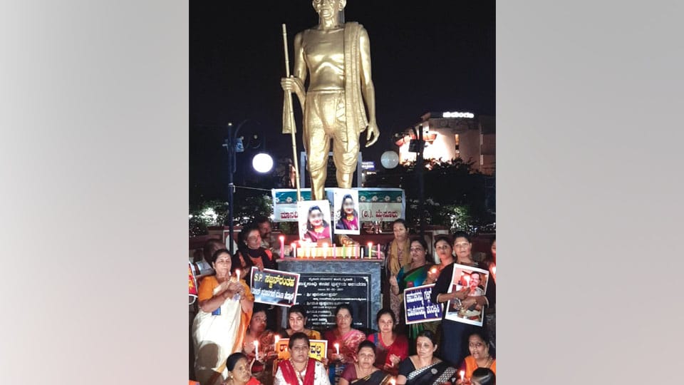 Women’s group stage candlelight protest against atrocities