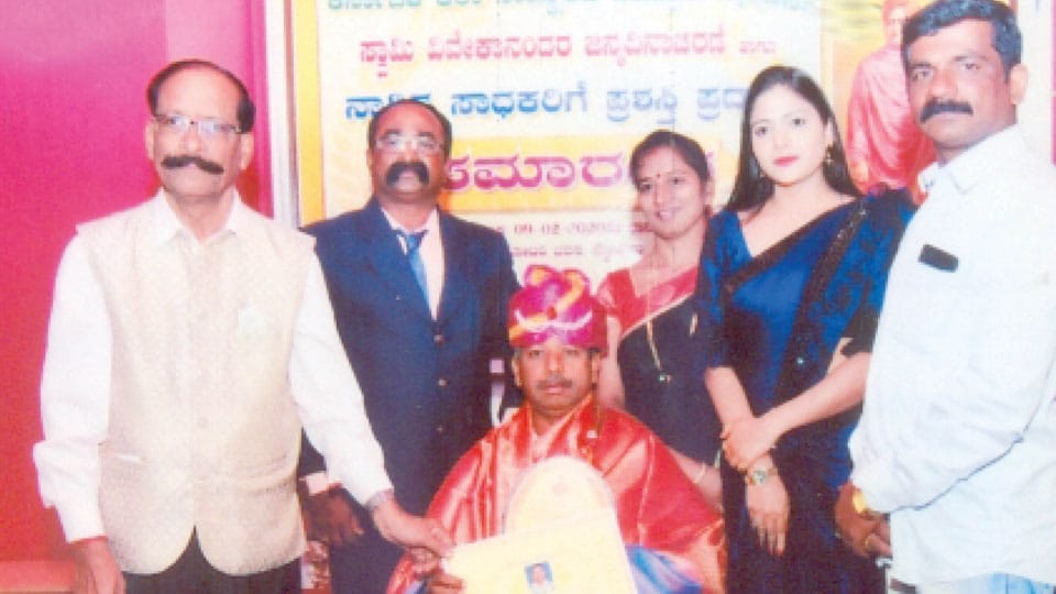 ‘Karnataka Seva Ratna’ conferred on swimming coach