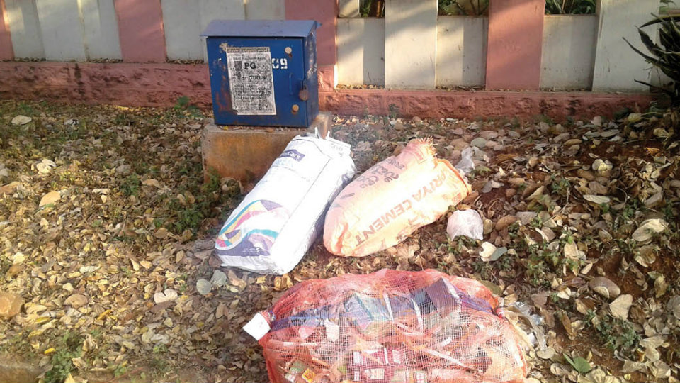 Clear garbage dumped in front of a house at Saraswathipuram