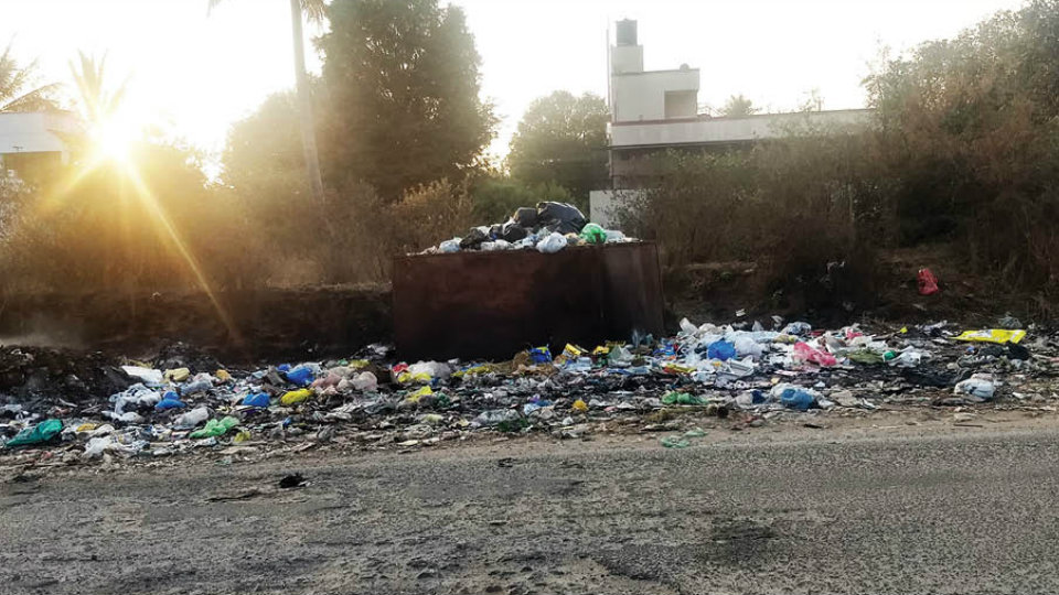 Uncleared garbage, burning of wastes, a nuisance at BEML Layout