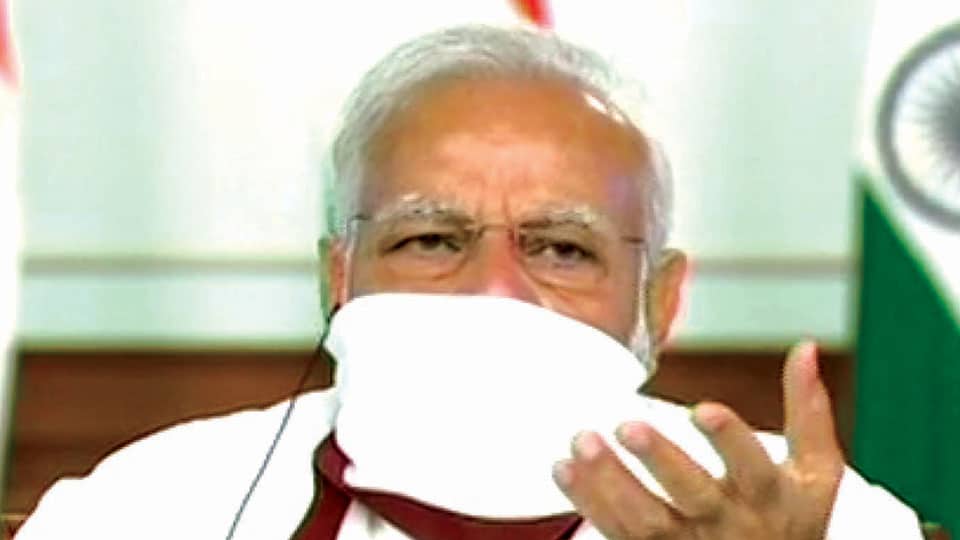 Modi wears home-made face mask, discusses lockdown situation with CMs