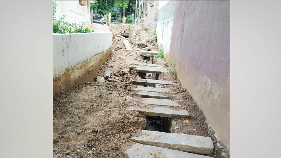 Water from blocked open drain gushing into houses at Yadavagiri
