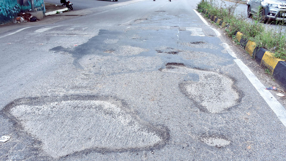 Potholed busy road crying for attention