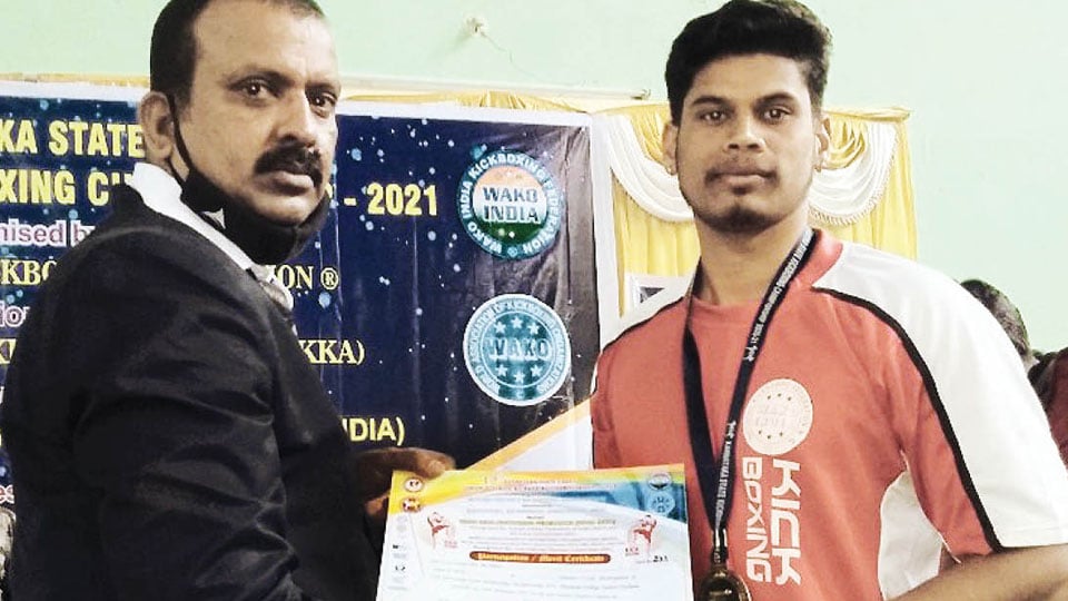 Research scholar wins gold in kick-boxing