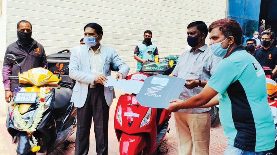 Minister launches distribution of two-wheelers to beneficiaries