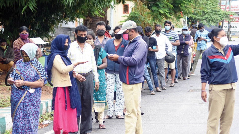 People queue up for RT-PCR testing amid incessant rains in city