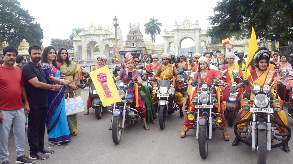 Women in traditional attire take out bike rally