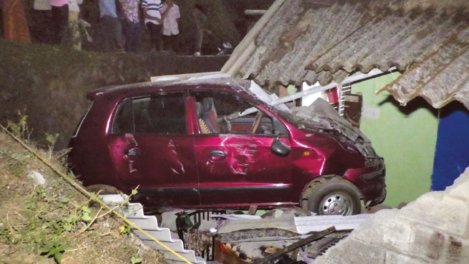 Wall collapses as car ploughs into house