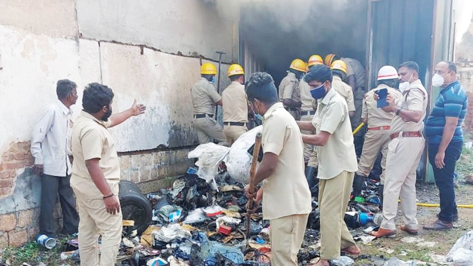 Garbage heap catches fire behind V.V. Market