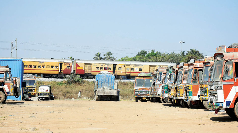 Railway Goods Shed Lorry Parking Row: Trucks park on MUDA land along Railway track