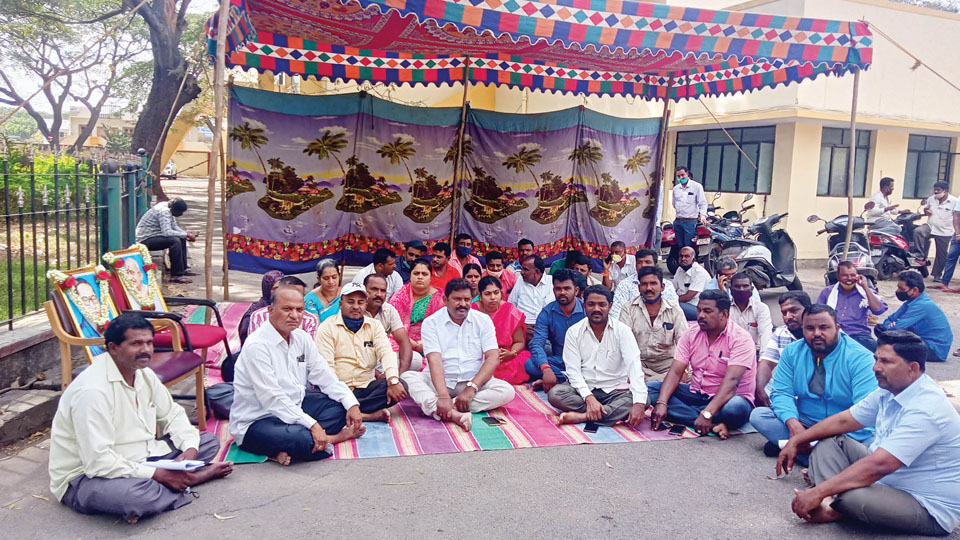 Hunsur MLA stages protest in front of PWD Office