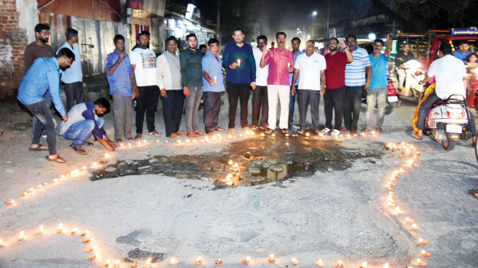As frustrated people light diyas on pothole-filled roads… MCC to smoothen bumpy roads after Deepavali