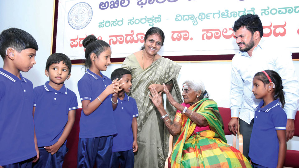 Vriksha Maate Dr. Saalumarada Thimmakka interacts with children at AIISH in city