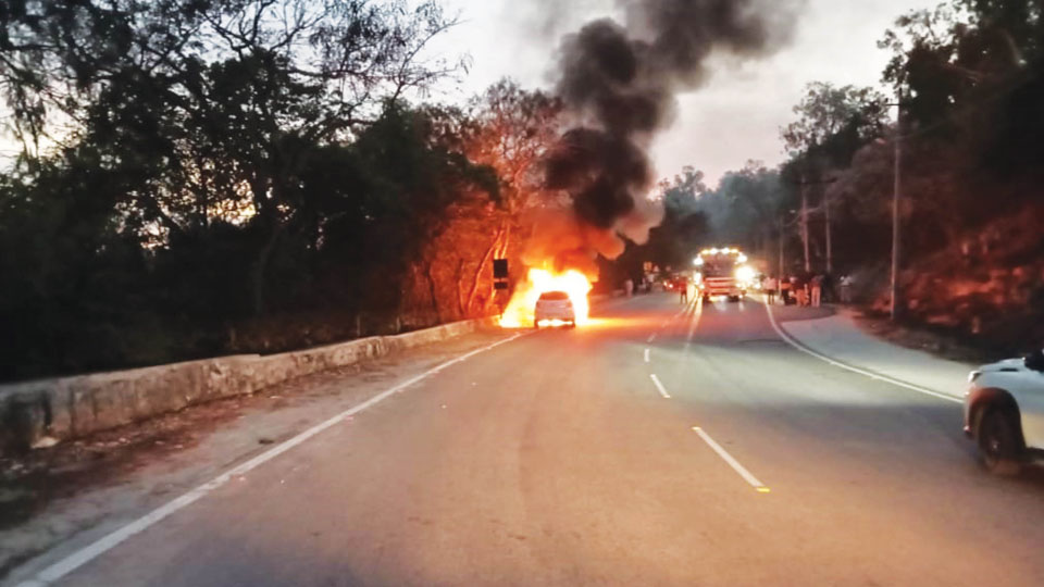 Miraculous escape for occupants as car catches fire atop Chamundi Hill