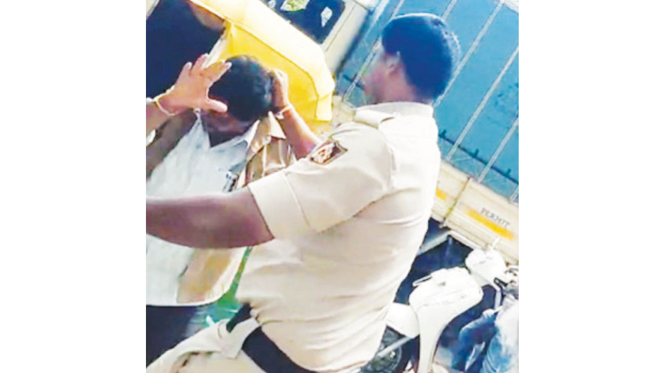 Cop suspended for assaulting auto driver