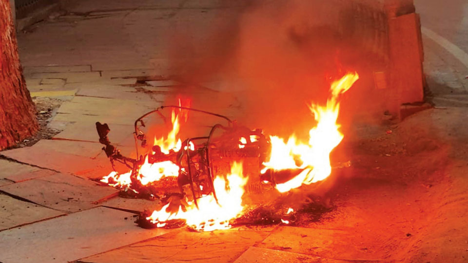 Moving electric scooter catches fire, explodes