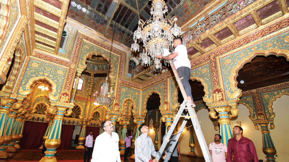 Cleaning chandelier at Palace
