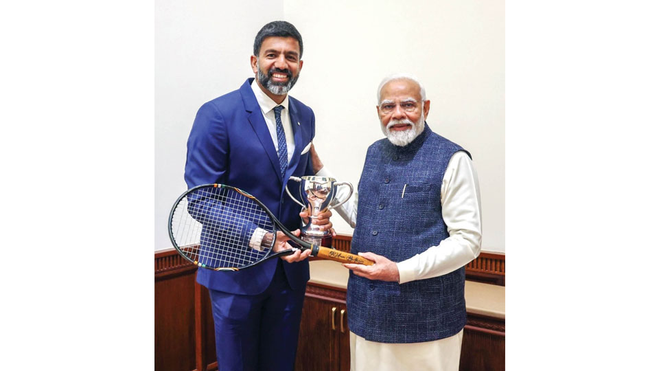 Bopanna presents his Australian Open winning racket to PM Modi