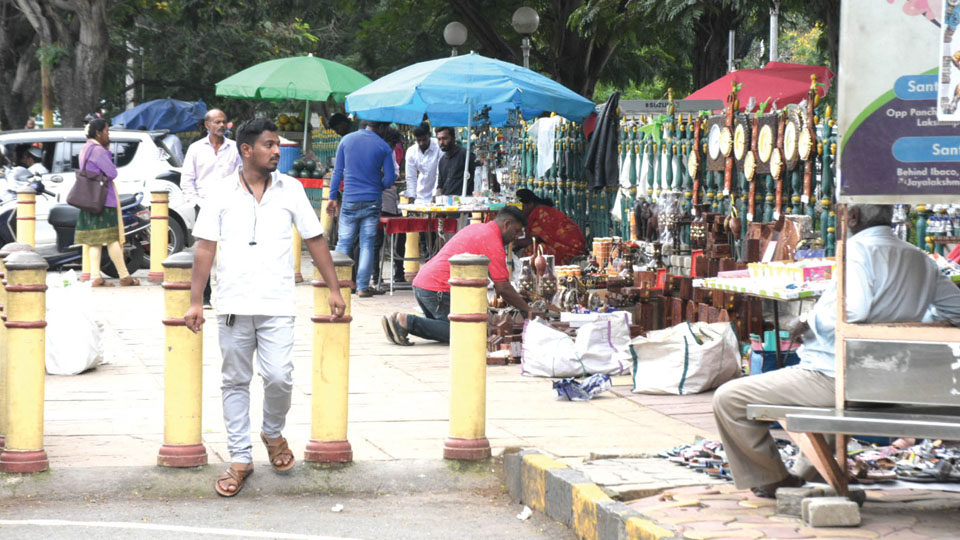 Mysore Palace, its unabated menace of footpath vendors