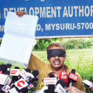 Blindfolded protest at MUDA meeting venue