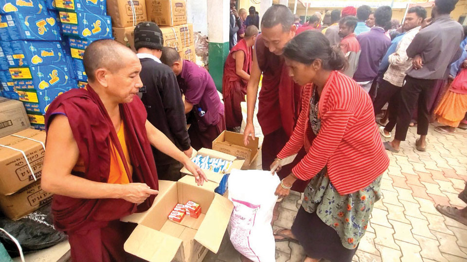 Tibetans distribute food grains
