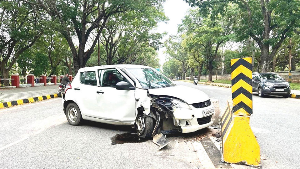 Woman injured as car hits road divider