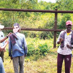 Back-to-front human face masks to keep tigers at bay