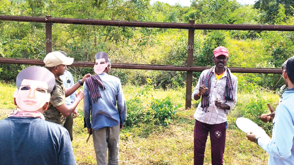 Back-to-front human face masks to keep tigers at bay