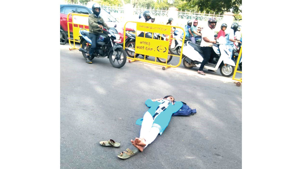 Demand of Rs. 18,000 for marks cards: Girl student lies on road in protest