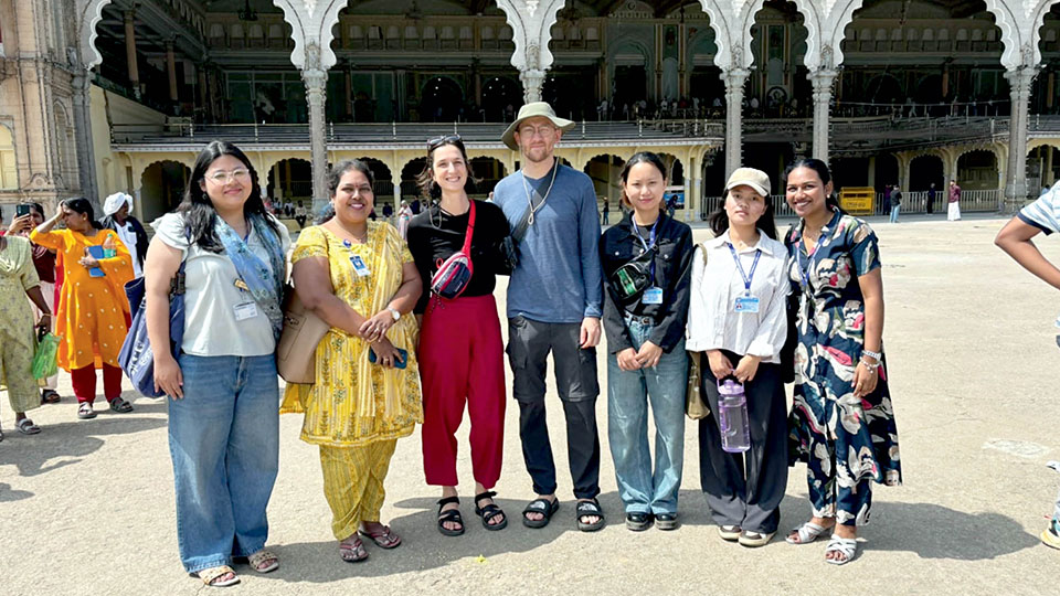 Teresian students guide tourists at Mysore Palace