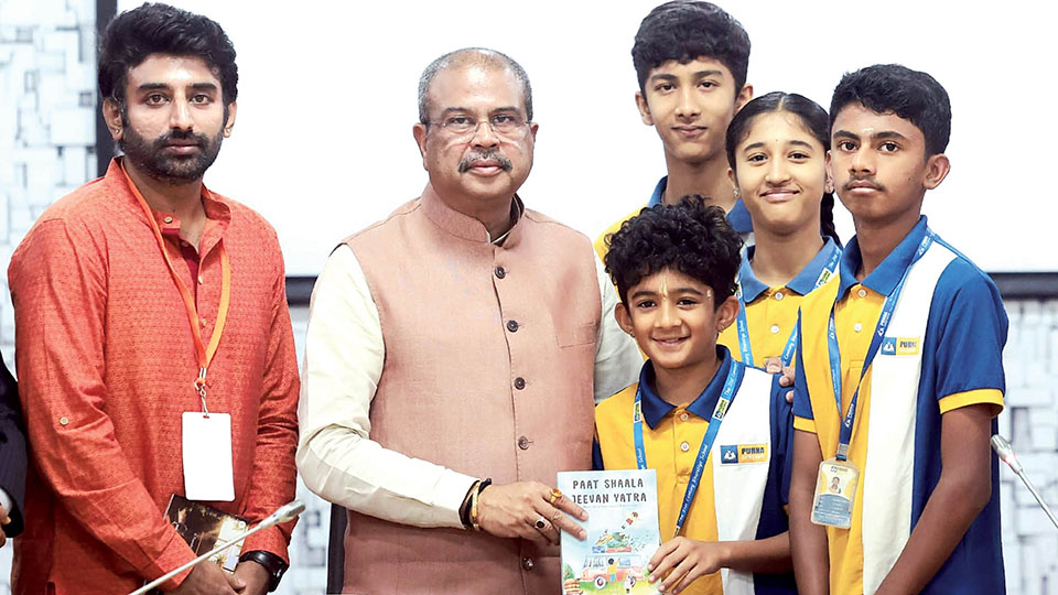 Purna Chetana students present their book to Education Minister