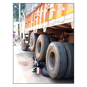 Rider escapes death as bike comes under truck