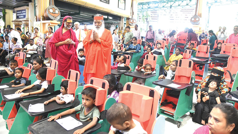 Sri Ganapathy Sachchidananda Swamiji distributes charities to differently abled