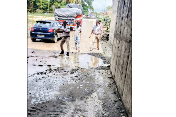 Police step in to fill waterlogged pothole